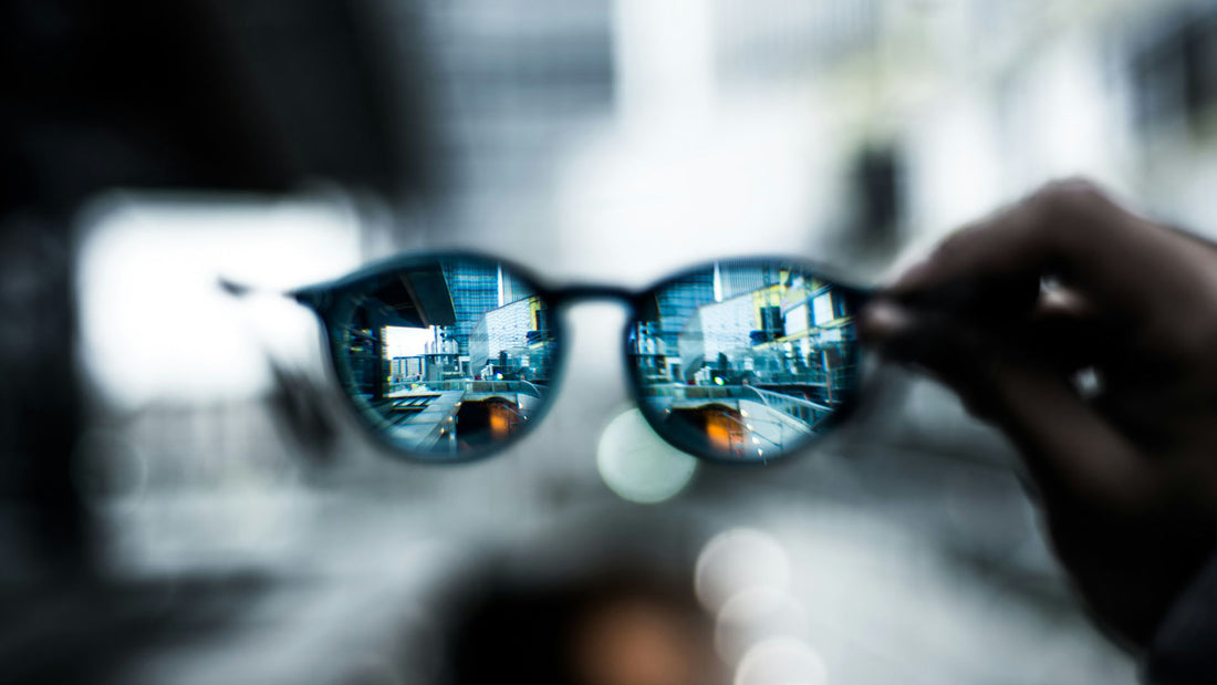 Blurred cityscape appears sharp through glasses